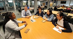 Image of staff and students meeting in a conference room
